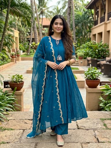 sophisticated peacock blue Anarkali suit set  luxurious Mul Chanderi fabric.