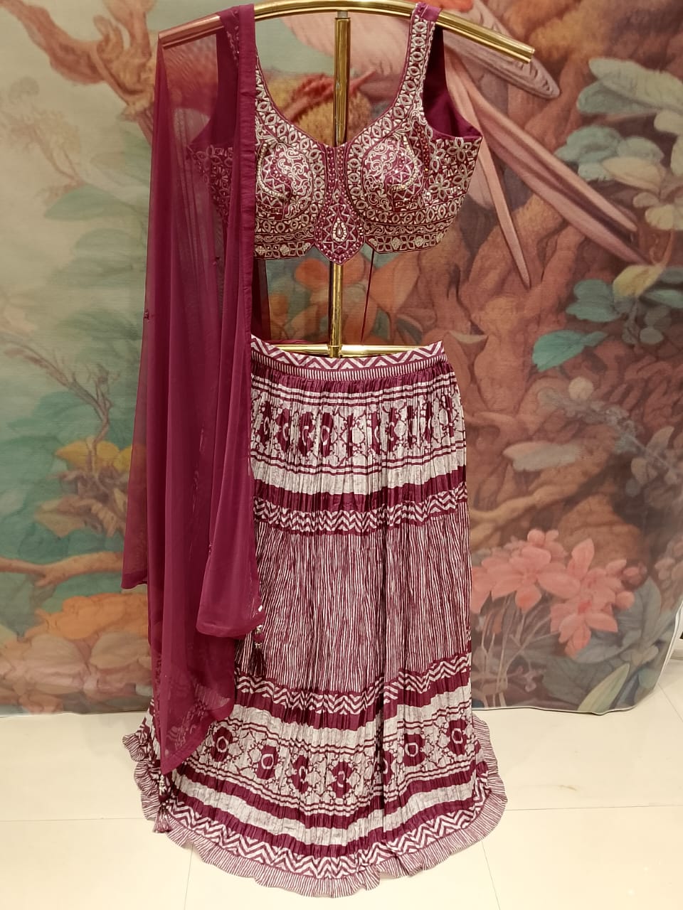 sophisticated wine-colored lehenga choli set premium Silk and crinkle-textured fabrics.