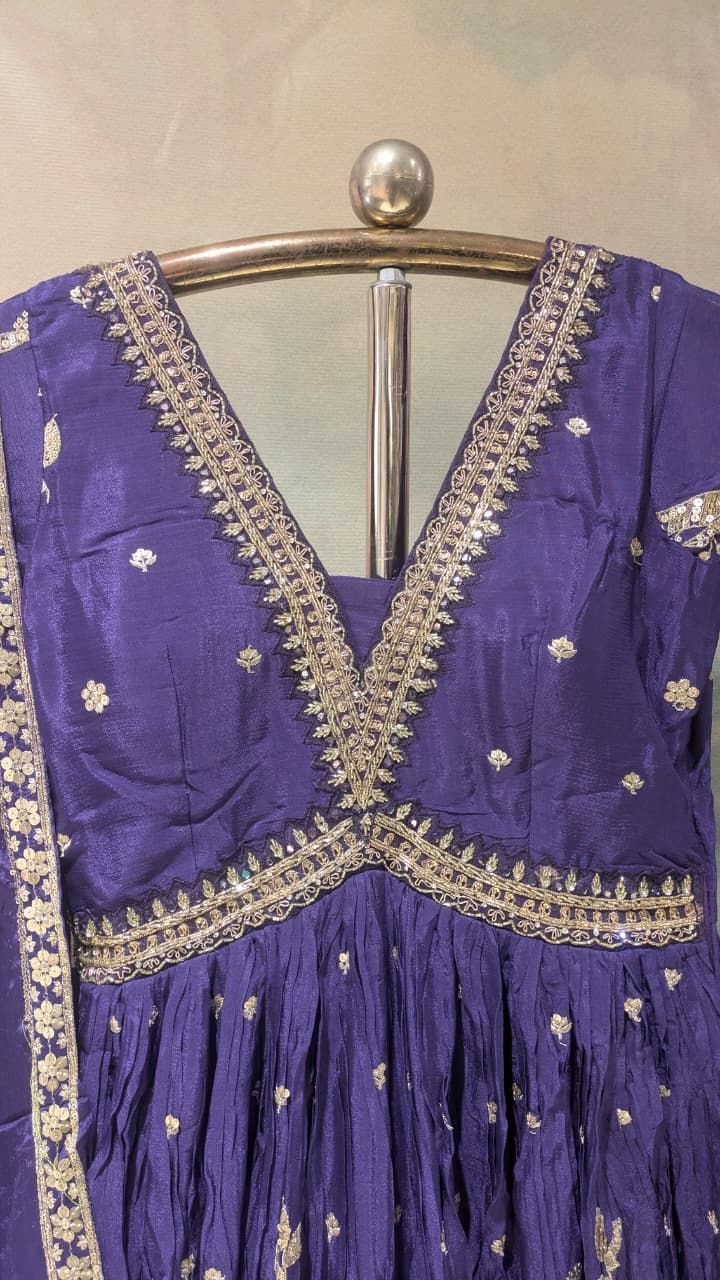 deep purple, floor-length traditional Georgette gown With embroidered dupatta.