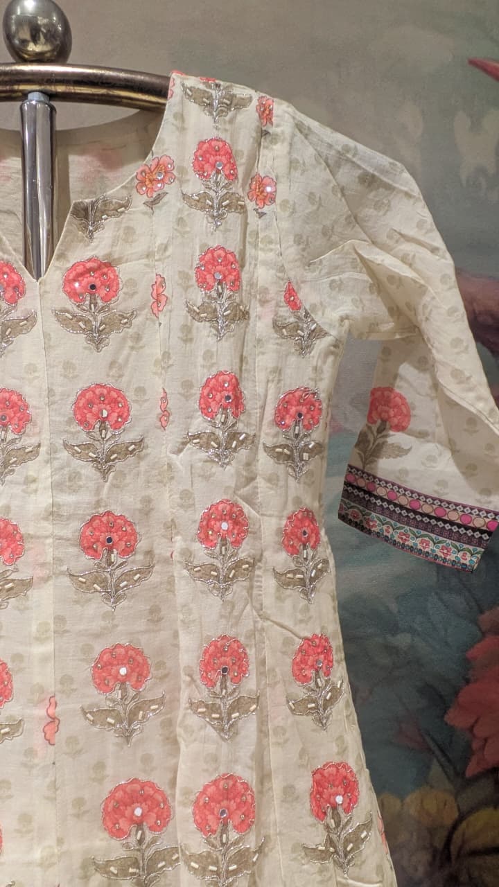 cream-colored, three-piece traditional ethnic ensemble Mul Chanderi Anarkali-style kurta straight-cut trousers, solid dupatta.
