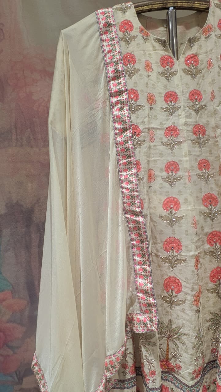 cream-colored, three-piece traditional ethnic ensemble Mul Chanderi Anarkali-style kurta straight-cut trousers, solid dupatta.