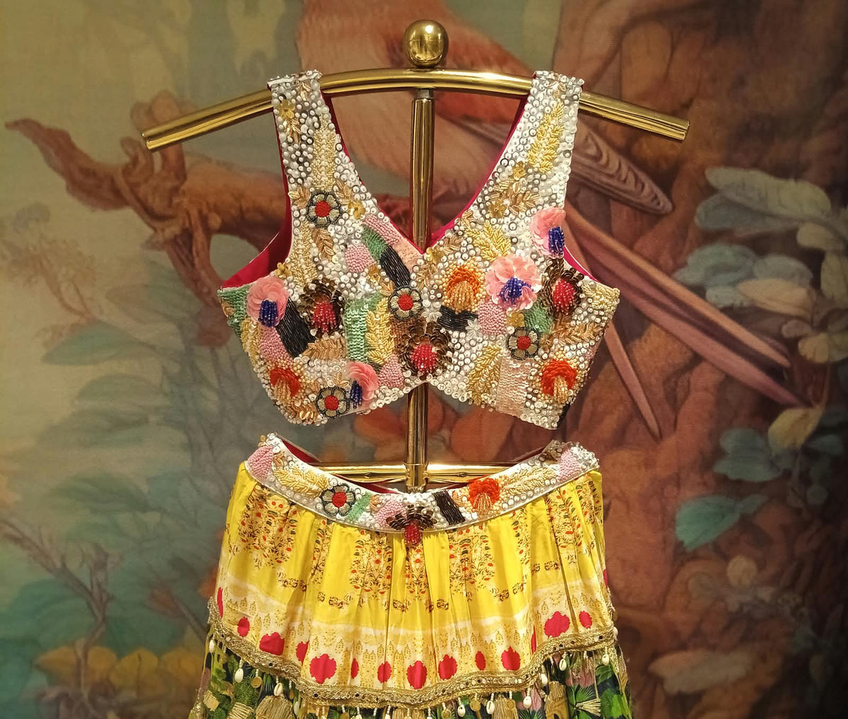 multi-colored, tiered festive Satin Silk lehenga choli printed lehenga skirt, and a navy-blue sheer dupatta.