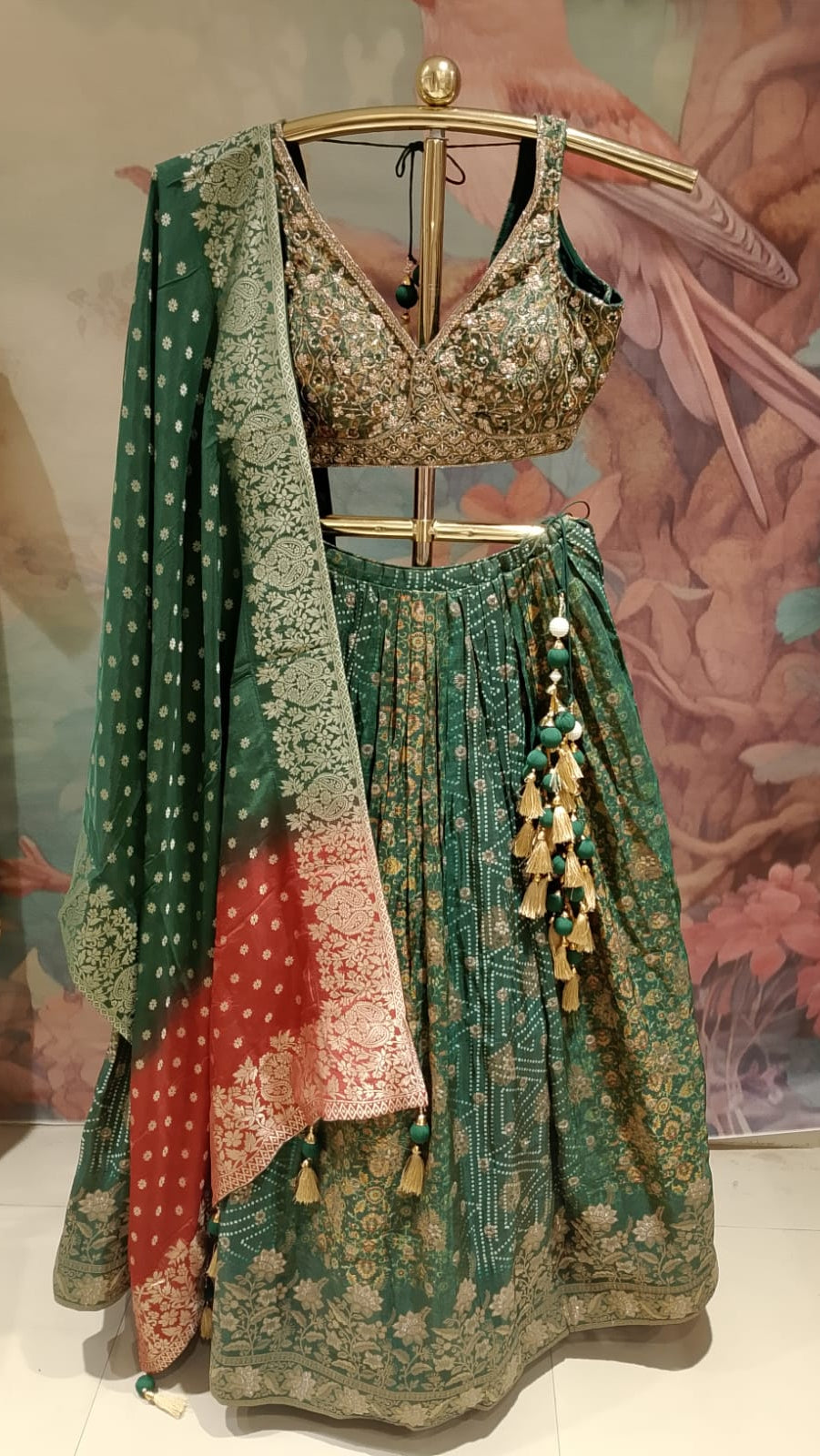 rich emerald-green and rust-red traditional Banarasi Silk lehenga choli printed lehenga skirt, and an ornate Banarasi-style dupatta.