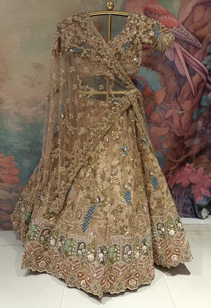 Champagne Gold Net Bridal Lehenga with Hand Peacock Heritage Embroidery.
