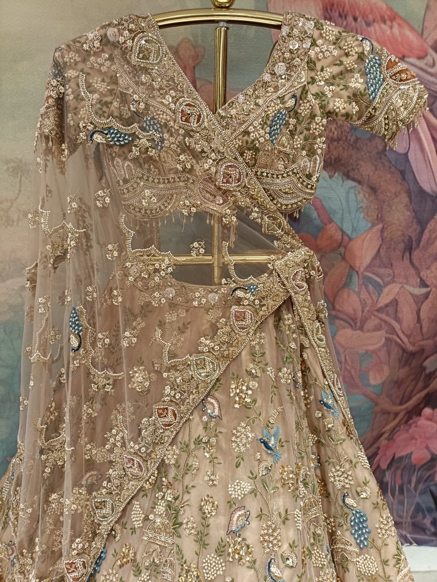 Champagne Gold Net Bridal Lehenga with Hand Peacock Heritage Embroidery.