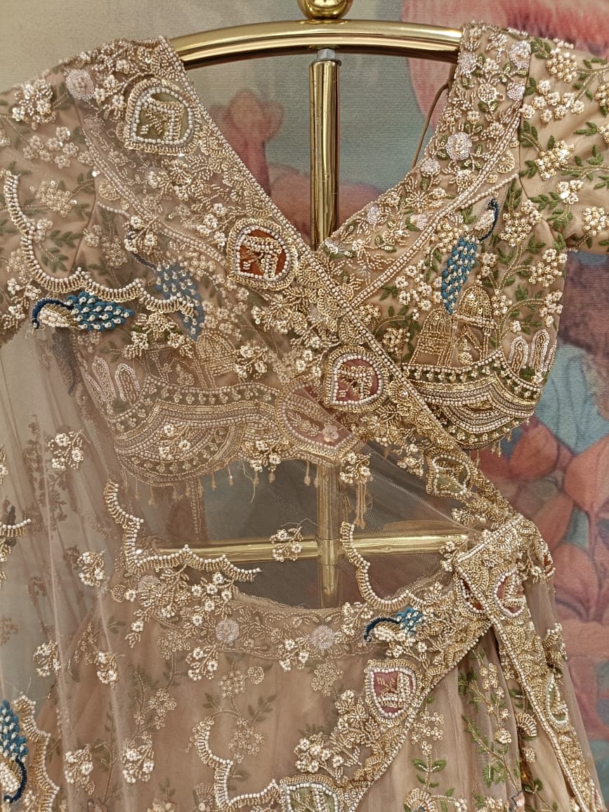 Champagne Gold Net Bridal Lehenga with Hand Peacock Heritage Embroidery.