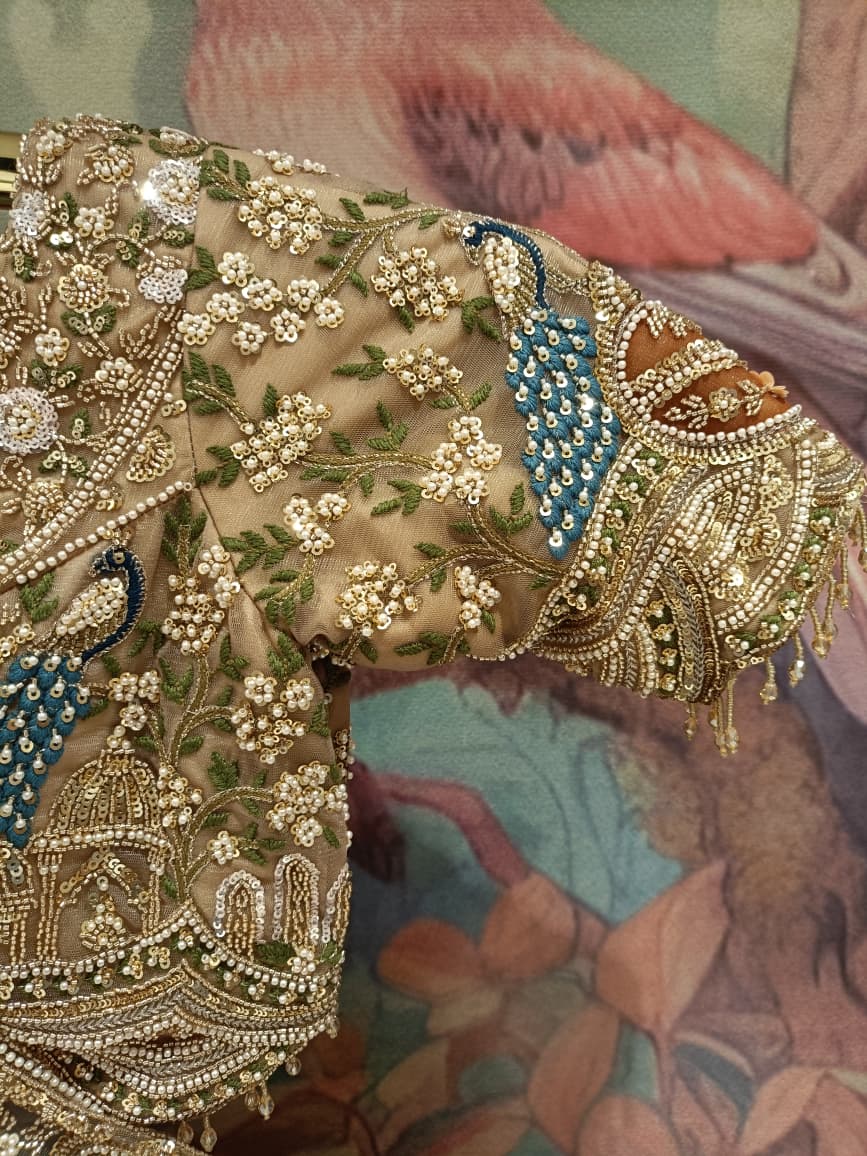 Champagne Gold Net Bridal Lehenga with Hand Peacock Heritage Embroidery.