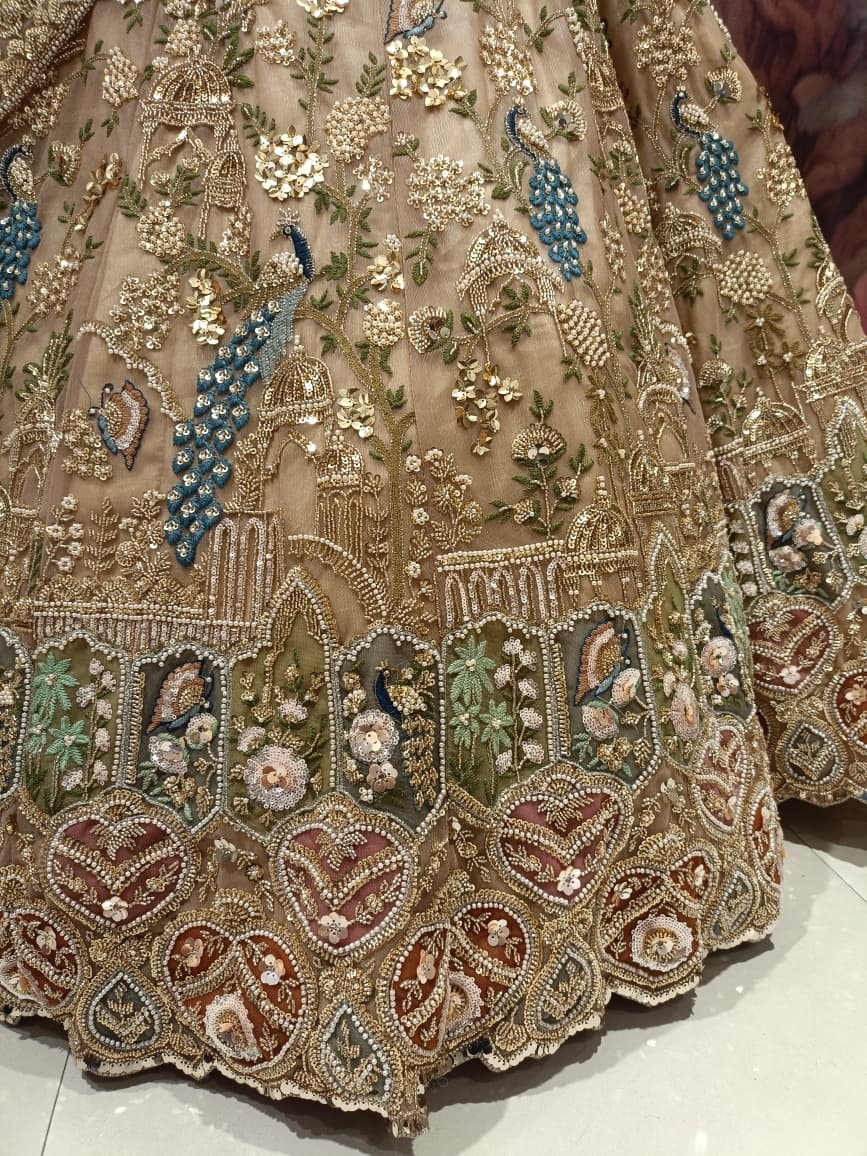 Champagne Gold Net Bridal Lehenga with Hand Peacock Heritage Embroidery.