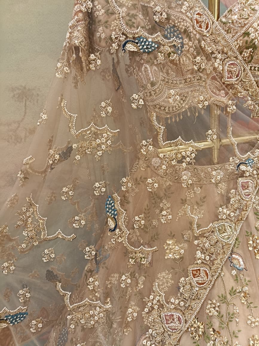 Champagne Gold Net Bridal Lehenga with Hand Peacock Heritage Embroidery.