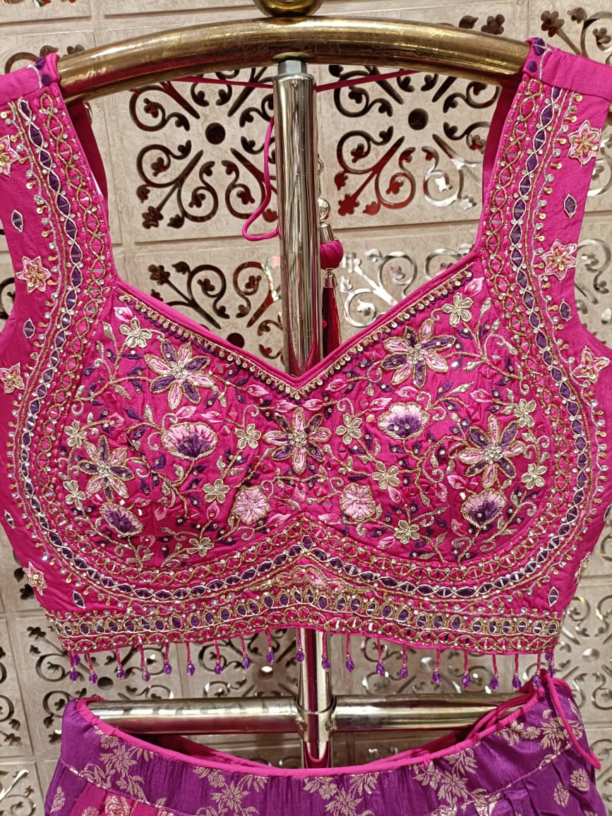 Rani Pink three-piece lehenga choli ensemble showcases a lively fusion of traditional and modern styling