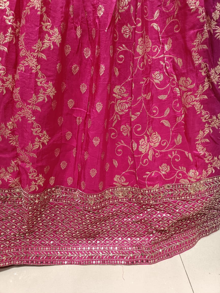 Rani Pink three-piece lehenga choli ensemble showcases a lively fusion of traditional and modern styling