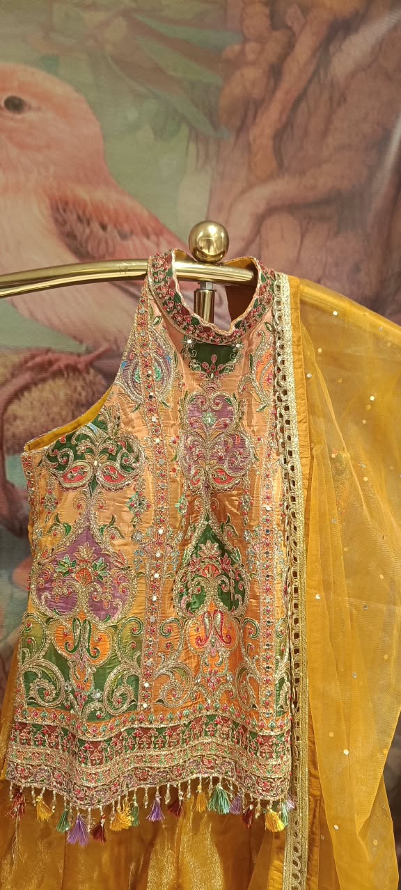 Three-piece luxury palazzo Set featuring a contemporary halter-neck tunic, heavily flared pants, and a sheer dupatta.