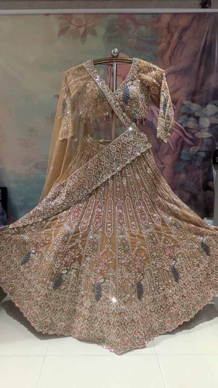 Opulent Beige-Gold Peacock Motif Bridal Lehenga Choli Set.
