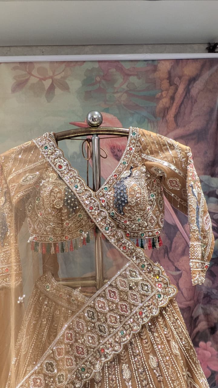 Opulent Beige-Gold Peacock Motif Bridal Lehenga Choli Set.