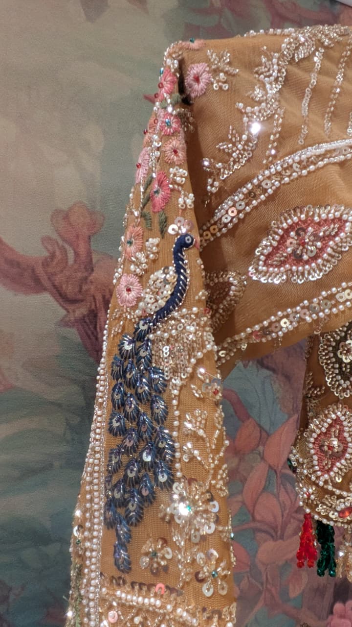 Opulent Beige-Gold Peacock Motif Bridal Lehenga Choli Set.