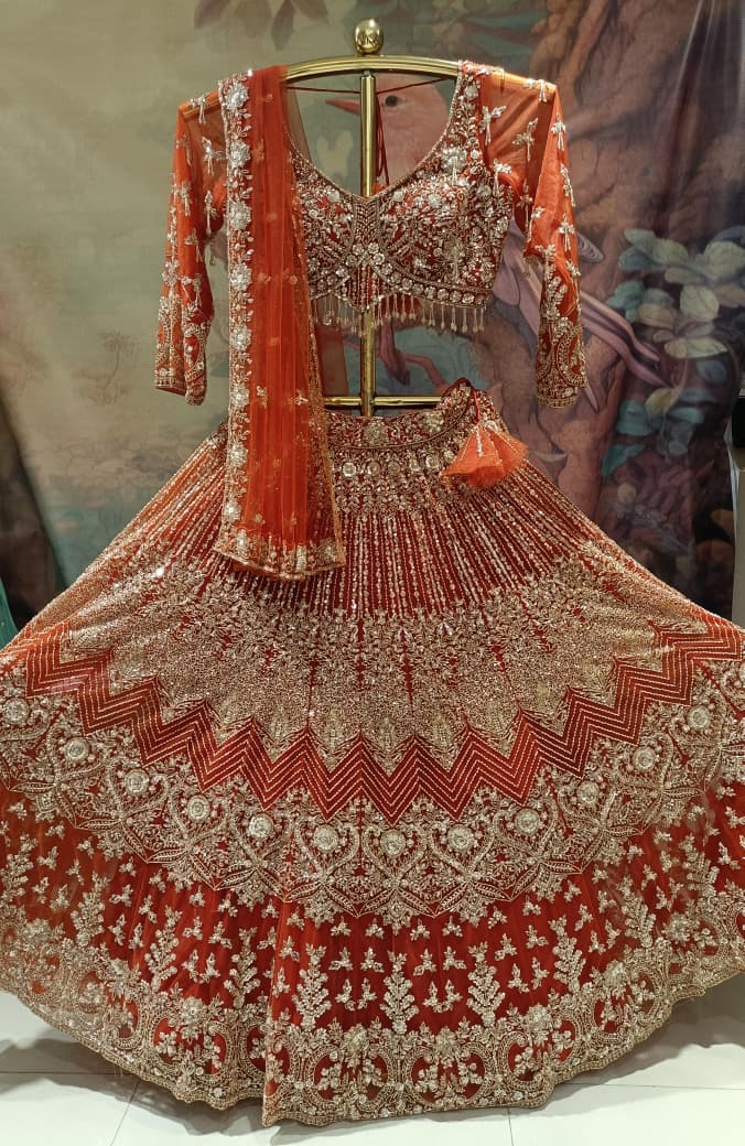 Ethereal Rust-Orange Hand-Embroidered Bridal Lehenga Choli Set.