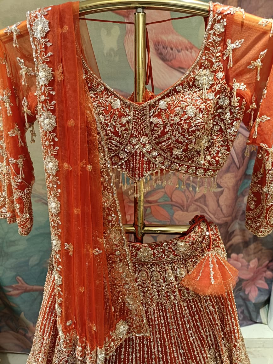 Ethereal Rust-Orange Hand-Embroidered Bridal Lehenga Choli Set.