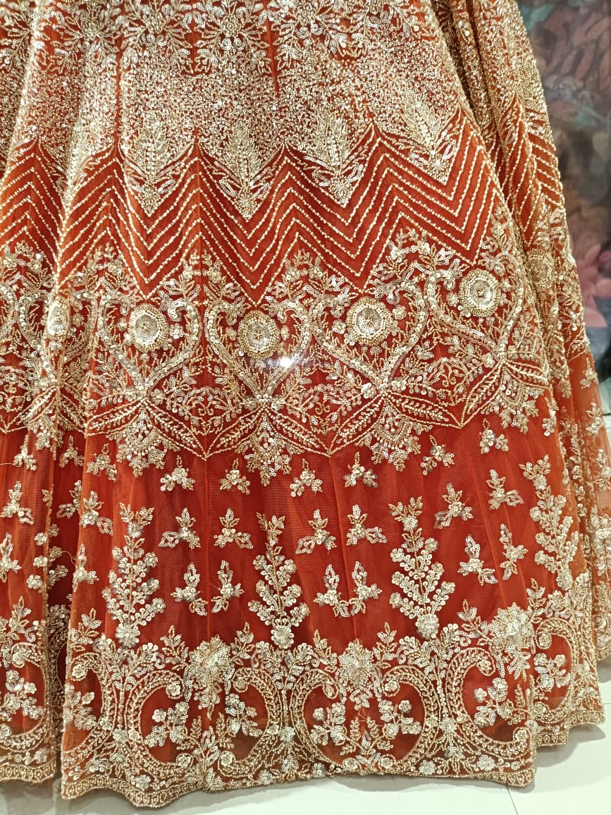 Ethereal Rust-Orange Hand-Embroidered Bridal Lehenga Choli Set.