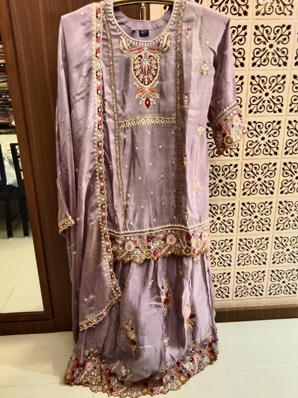 This is a premium, elegant 3-piece traditional ethnic ensemble designed to bring out a sophisticated and festive look.