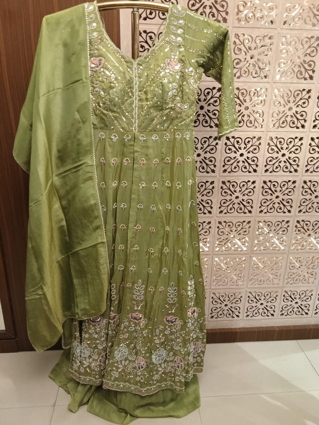 This stunning olive green Anarkali suit set blends traditional elegance with contemporary grace