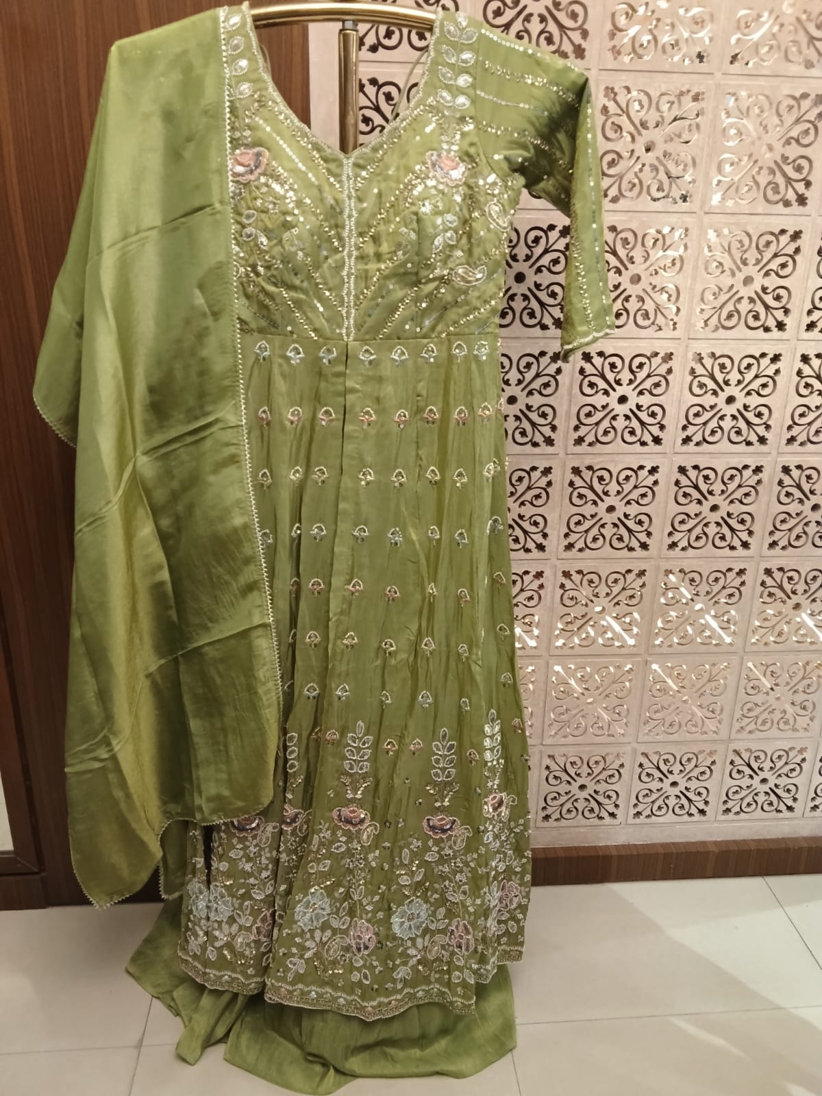 This stunning olive green Anarkali suit set blends traditional elegance with contemporary grace