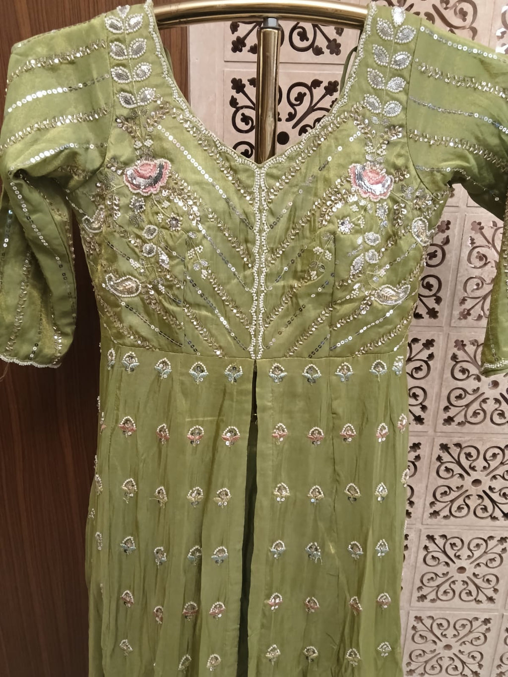 This stunning olive green Anarkali suit set blends traditional elegance with contemporary grace