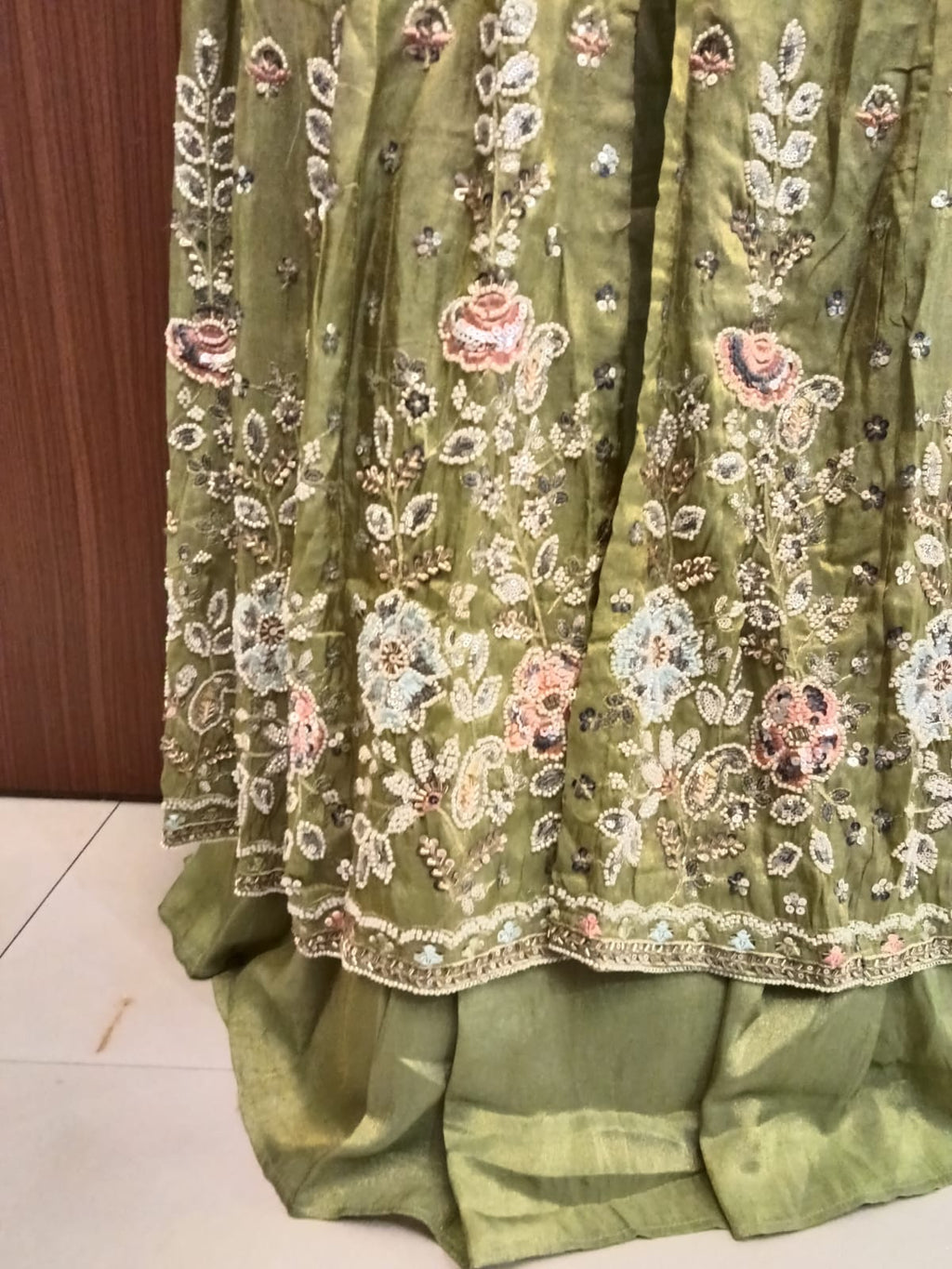 This stunning olive green Anarkali suit set blends traditional elegance with contemporary grace