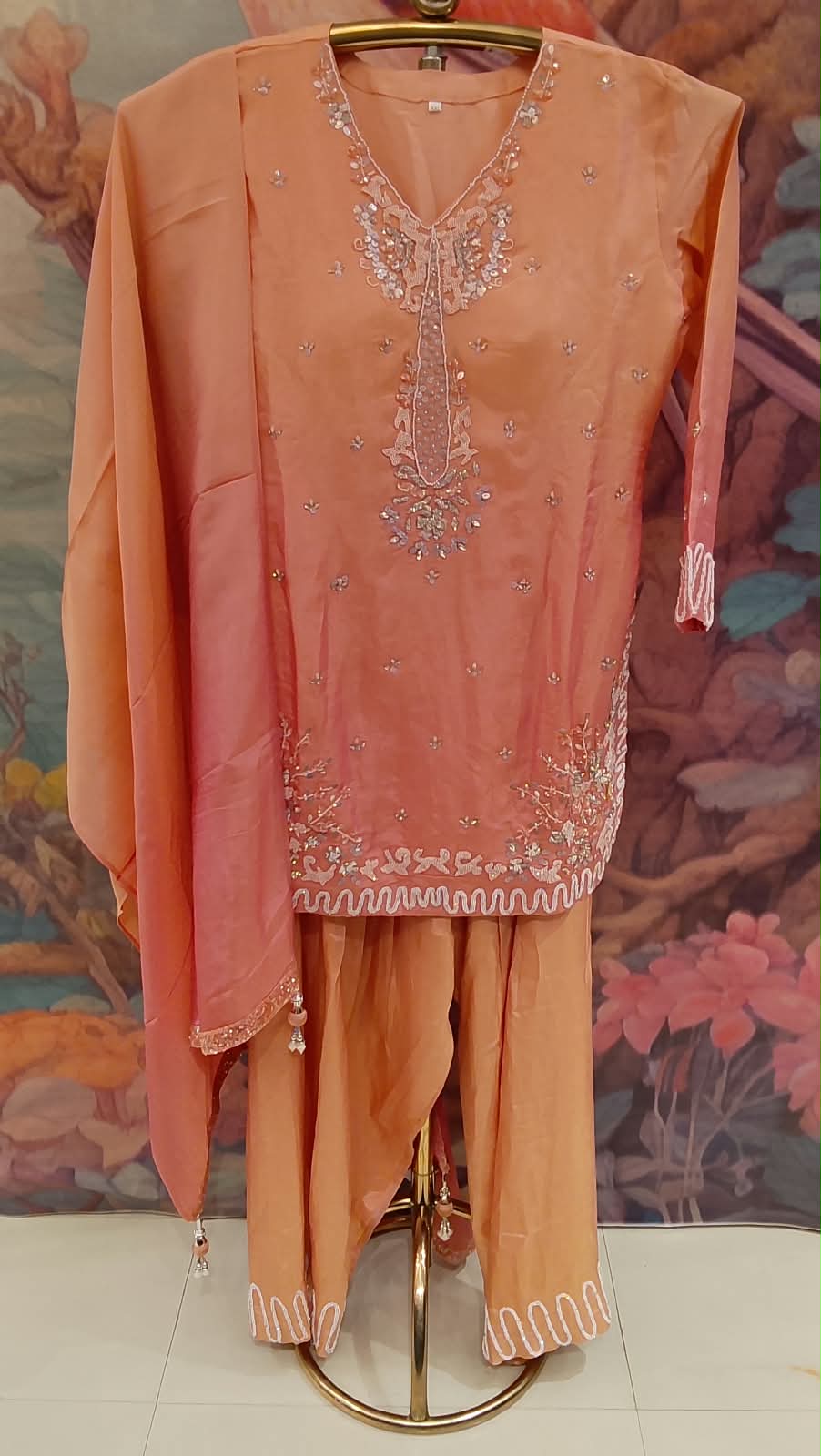 Elevate your festive wardrobe with our stunning Peach Orange and Champagne Salwar Suit Set. Ideal for festivals, family gatherings, and pre-wedding events.