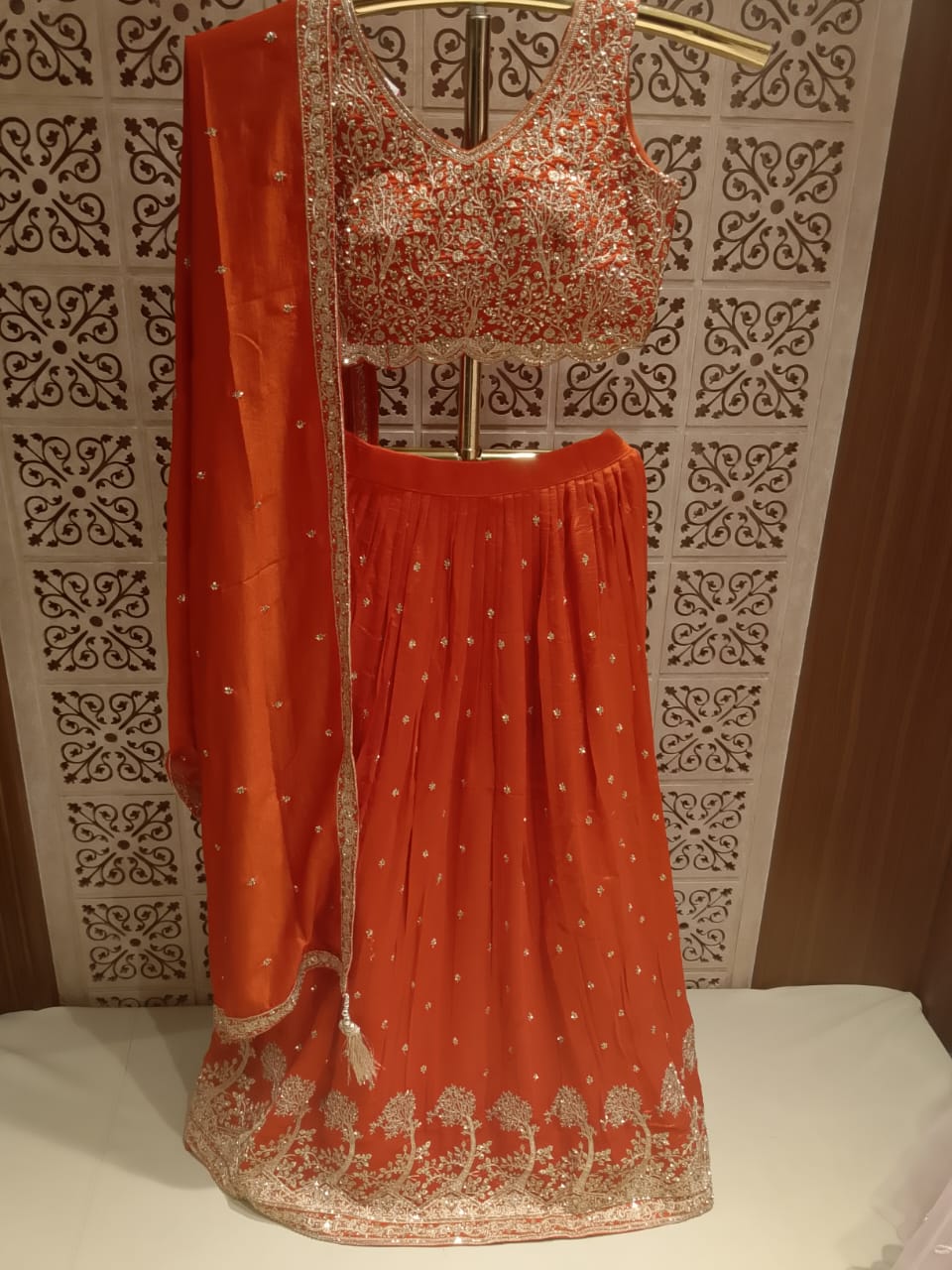 Opulent Rust Orange Embroidered Georgette Lehenga Choli Set.