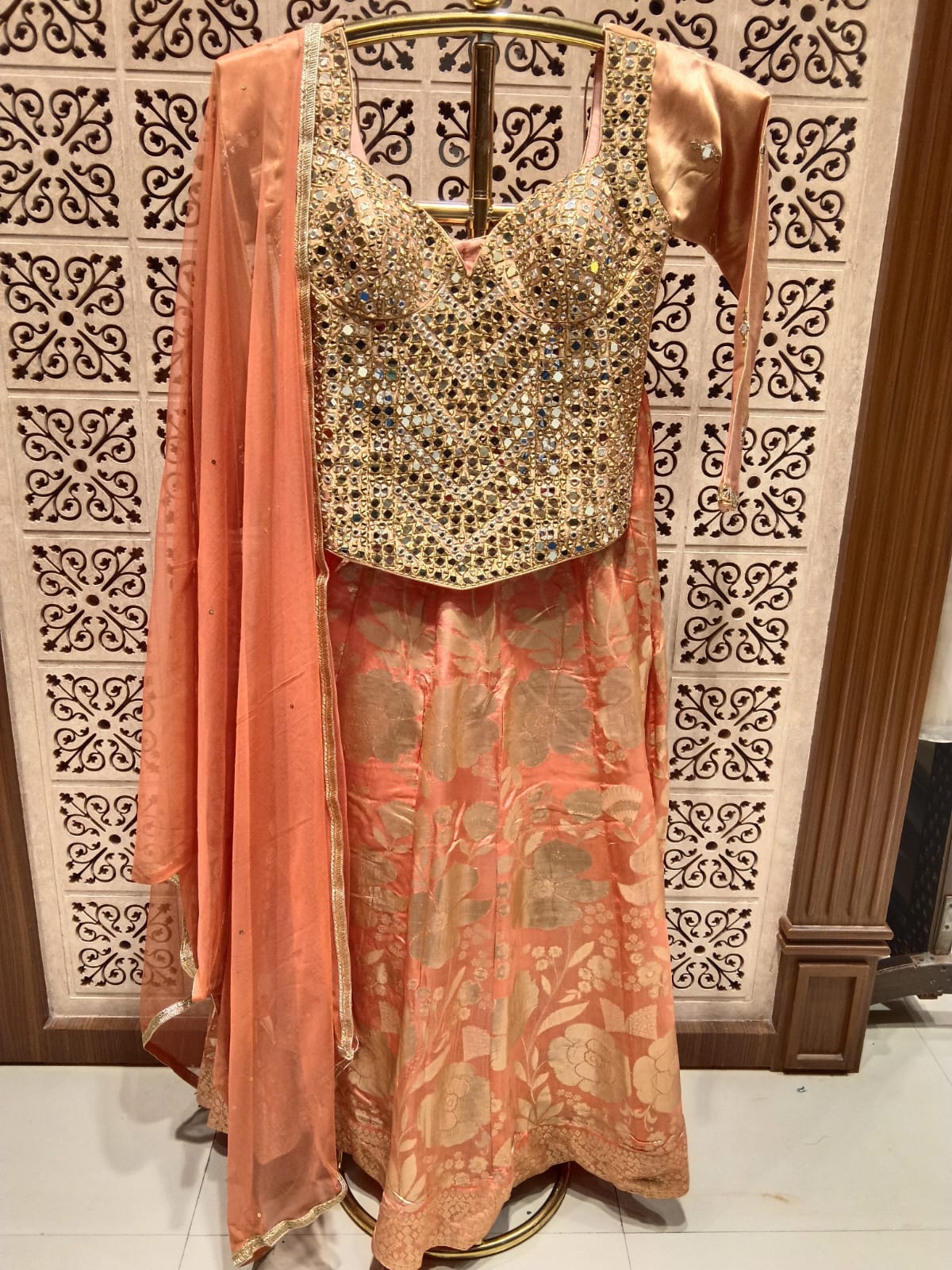 Simmer Peach Banarasi Lehenga with Heavy Mirror Corset Blouse.